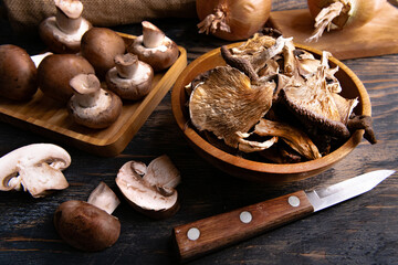 Mix dried mushrooms in wooden bowl. Close up mushrooms