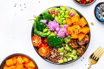 Fotobehang Vegan buddha bowl with baked pumpkin, quinoa, tomatoes, spinach, celery, radish, soybeans, edamame, tofu, cauliflower, broccoli and sesame seeds, white table background, top view © 5ph