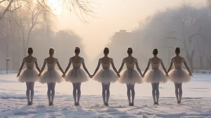 Crédence de cuisine en verre imprimé Gris a group of ballerinas in a row on a nature landscape in winter dancing ballet in the morning fog like white swans on a lake