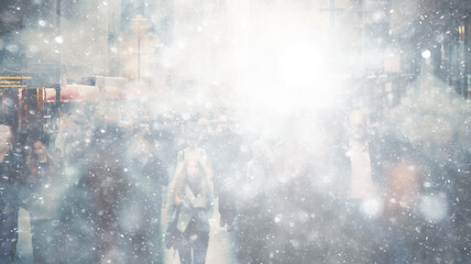 winter background snowfall in the city, copy space abstract blurred white background snowflakes falling on a crowd of people
