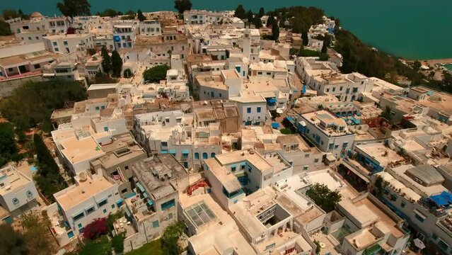 Aerial Tilt Up Beautiful View Of Town On Cliff By Sea During Sunny Day - Mahdia, Tunisia