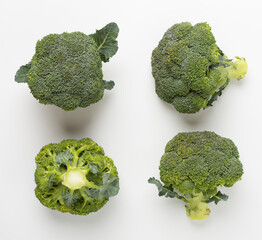 Flat lay with fresh broccoli on white background