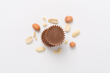 Tasty chocolate peanut butter cups on color background, top view