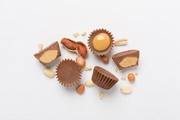 Tasty chocolate peanut butter cups on color background, top view