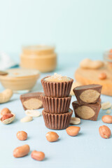 Tasty chocolate peanut butter cups on wooden table