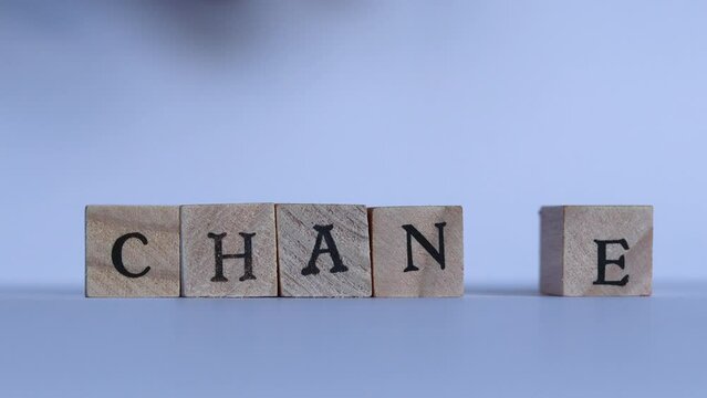 A hand alters the word "Chance" to "Change" switching letters