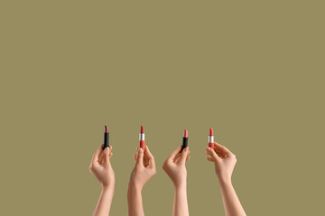Women with lipsticks on green background