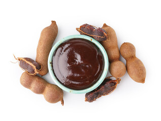 Bowl with tasty tamarind jam with fruits on white background