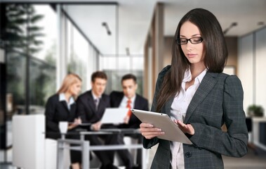 Mature smart businesswoman standing in office.