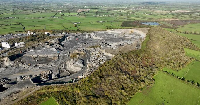 An aerial view of a large quarry polluting the environment in 4k
