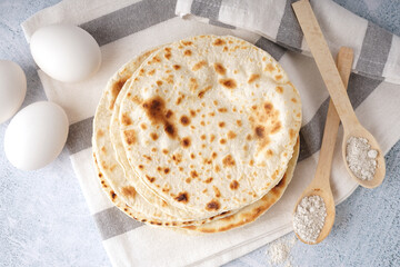 Tasty pita bread, eggs and flour on white background