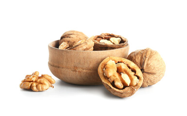 Bowl of tasty walnuts on white background