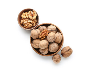 Bowls of tasty walnuts on white background