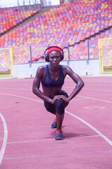 Athletic woman stretching on the track