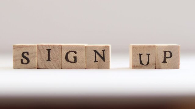 Hands spell out SIGN UP with block letters
