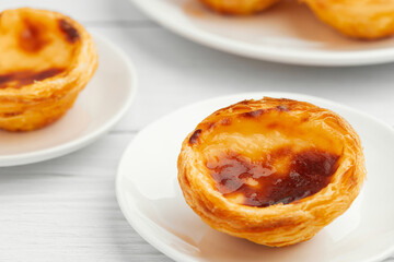 Traditional Portuguese egg tart dessert Pasteis Pastel de nata or Pasteis de Belem on the plate over white background