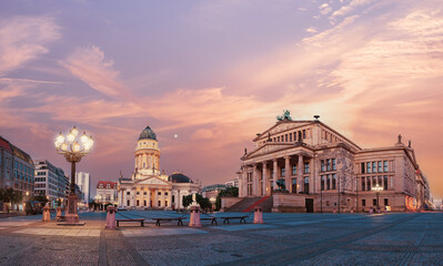 Panorama image of Gendarmenmarkt square in Berlin with Cathedral and Concert Hall at dawn.