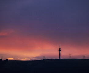 Sunset with mountain views and a radio tower
