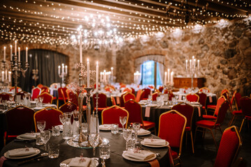Big empty modern meeting, seminar, conference room in hall. A large banquet hall, with round tables and red chairs.