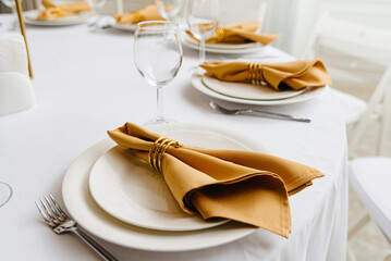 Elegance and Simplicity: A White Table Set With Minimalistic White Plates and Shiny Silverware