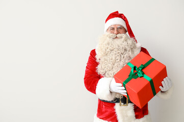 Santa Claus with Christmas gift on white background