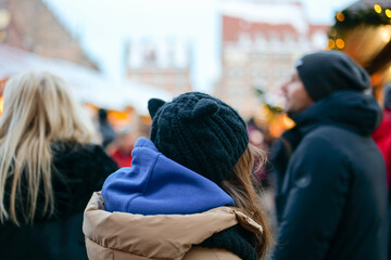 Christmas markets atmosphere in Germany.People at a European Christmas market. child and a crowd of...