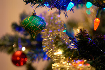 Green Christmas Tree Decoration and Lights. Festive holiday decorations on a Christmas tree.

