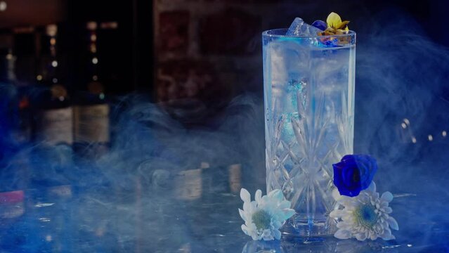 Dry ice blowing near an iced drink in a bar