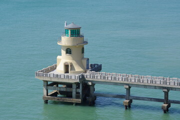A lighthouse on a bridge over the sea coastal