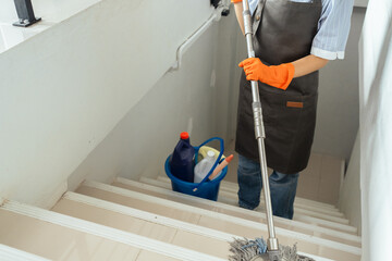 Asian cleaning service housekeeper women swipe floor in office