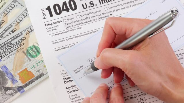 Close-up shot of a check being written for taxes.