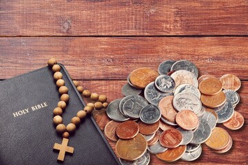 Holy Bible book and money coins