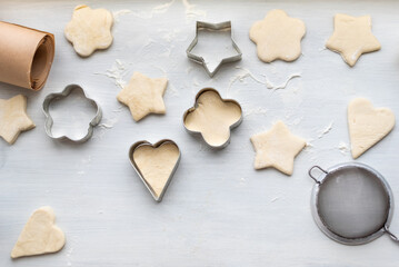 Top view of cooking a gingerbread cookie in the form of heart, star, cloud and flower. Christmas and New Year concept, festive preparations for winter hilodays.