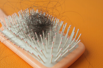 a brush with lost hair on table 