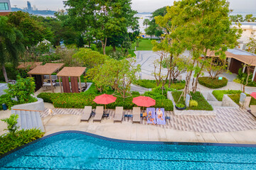 drone view from above at a couple swimming in an infinity pool on a luxury vacation in Thailand, man and woman in a pool of a luxury hotel in Thailand on vacation