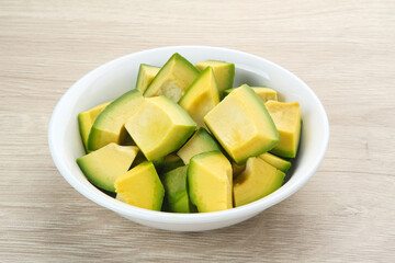 Slice of Alpukat or Avocado (Persea americana), ripe and fresh, served in white bowl
