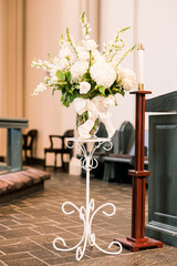 A flower arrangement on a stand inside a Christian protestant church 
