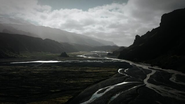 Beautiful aerial thor valley, glacial river flowing through black volcanic mountain, thorsm&ouml;rk landmark cinematic Iceland	