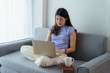 Naklejka premium Happy beautiful Asian Woman. Business woman working from home with laptop Financial Home work space concept.