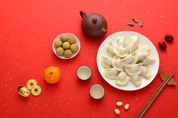 Delicious dumplings on a red background in China. The Chinese meaning in the picture is: attracting wealth and treasures