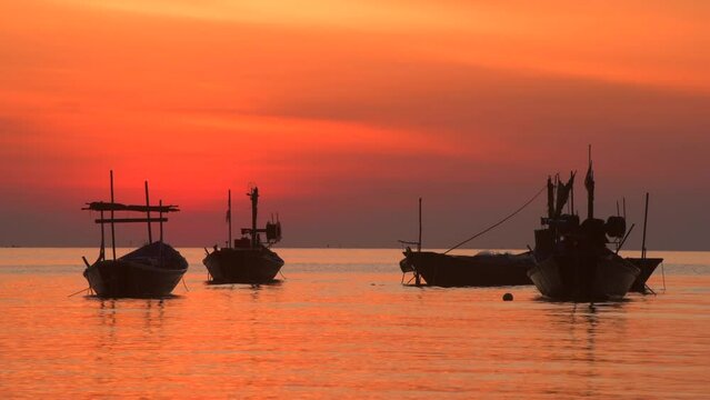 Sunset seascape with shadow of a small wooden boat in 4K video with natural warm orange light