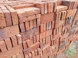 pile of red bricks near the manufacturing factory.