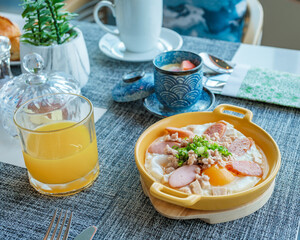 breakfast with fried eggs in a pan with bacon and vegetables, breakfast in a luxury hotel in Thailand, Fried eggs in a small pan with minced pork and sausages