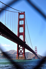 View of The Golden Gate Bridge through a Wire Fence in Fort Point - San Francisco, California