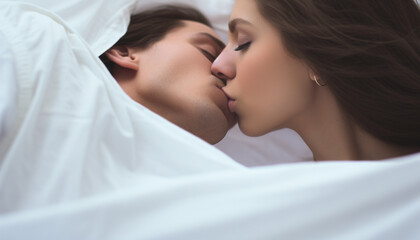 couple kissing in bed
