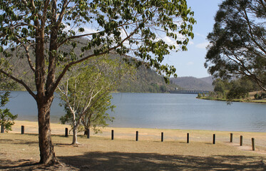 Fototapeta na wymiar Somerset Dam with trees and a dam wall in Queensland, Australia