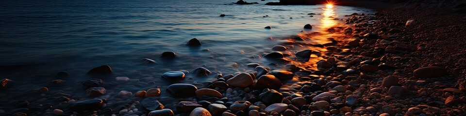 sunset reflecting over rocks and ocean