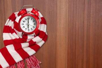 Clock changing from summer to winter time. Clock in scarf
