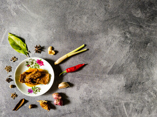 Rendang or Randang Indonesian food most delicious food in the world with various herb and spices and abstract background. With copy space.
