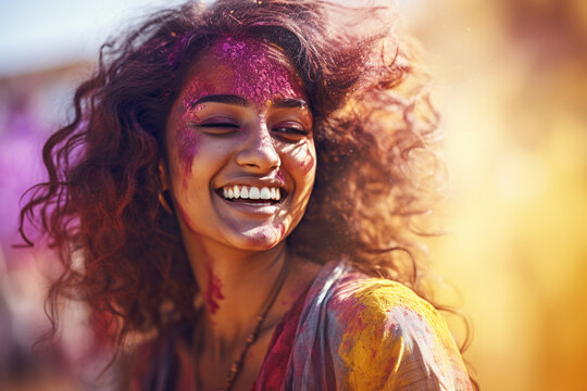 happy indian woman with holi powder on her face at holi festival bokeh style background